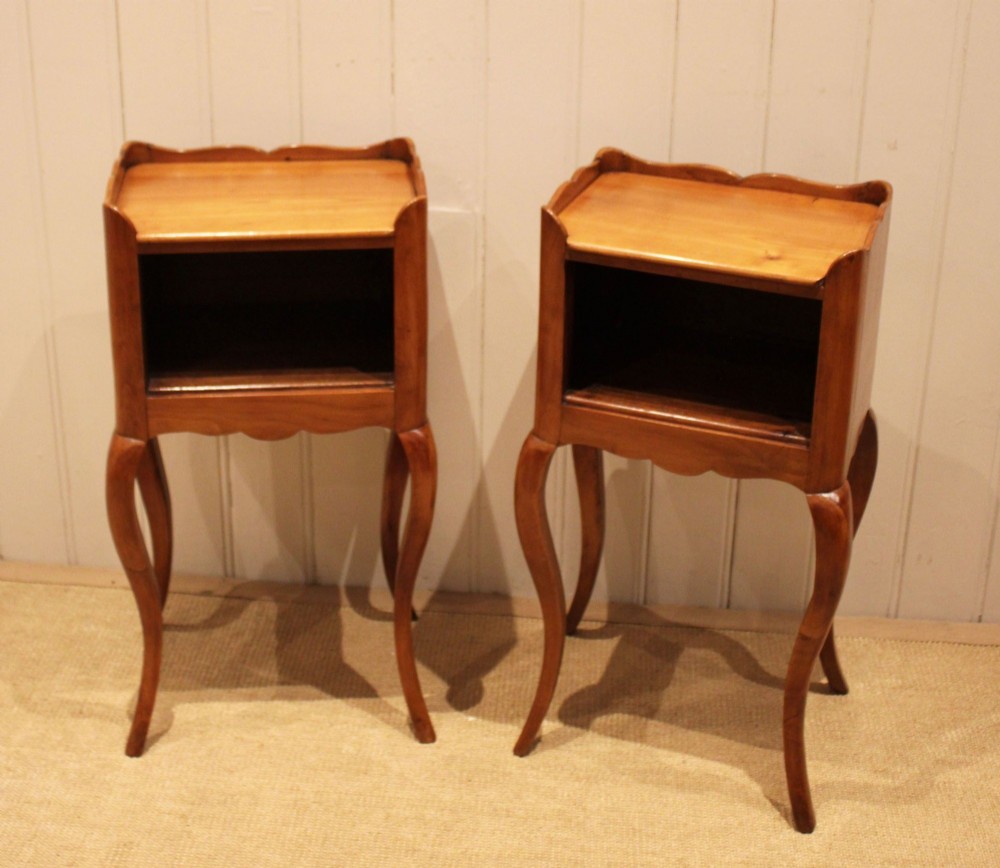 A pair of warm brown cherry wood bedside cabinets featuring open shelf compartments, scalloped top galleries, and slender cabriole legs. View VII