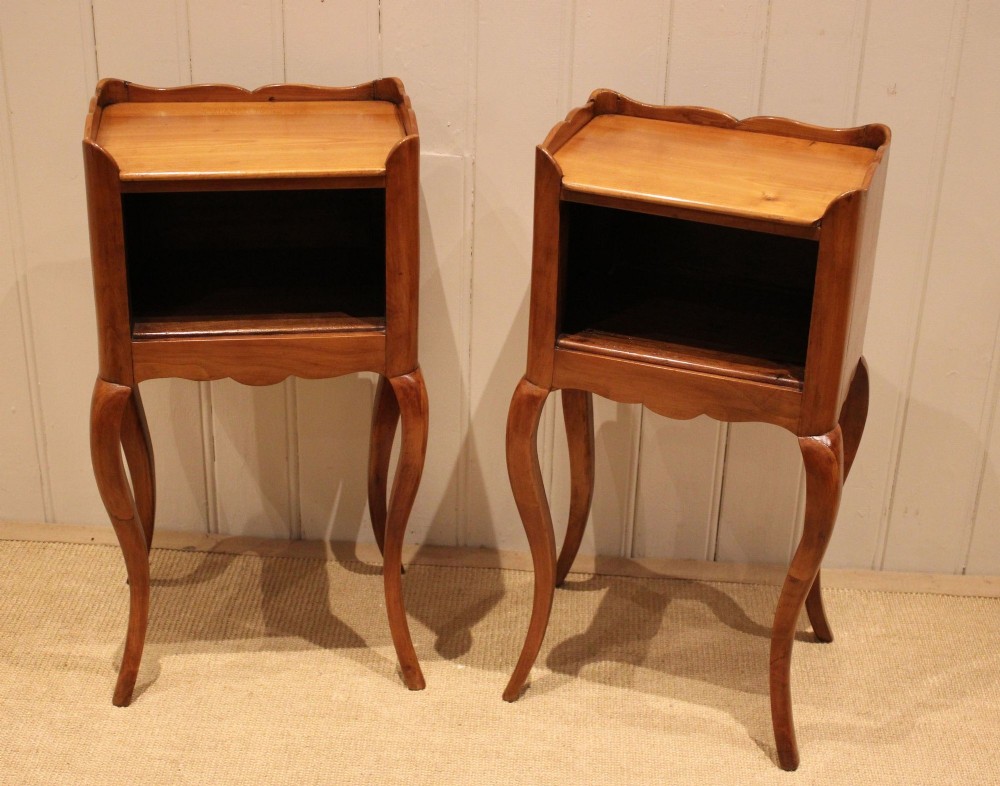 A pair of warm brown cherry wood bedside cabinets featuring open shelf compartments, scalloped top galleries, and slender cabriole legs. View VIII