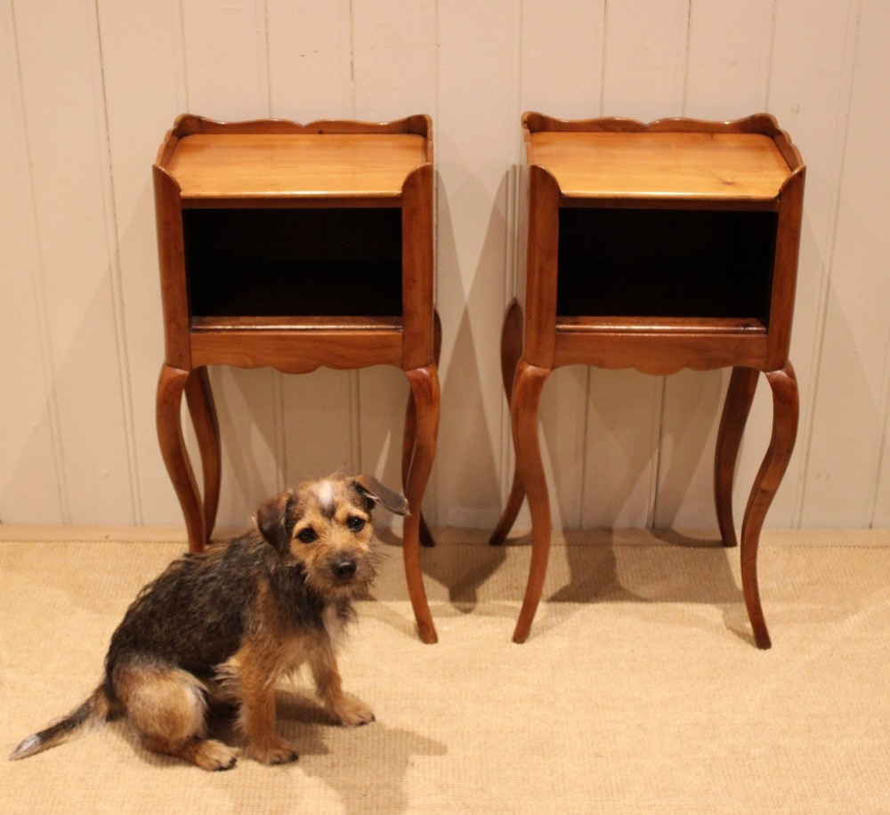 A pair of warm brown cherry wood bedside cabinets featuring open shelf compartments, scalloped top galleries, and slender cabriole legs. View IX
