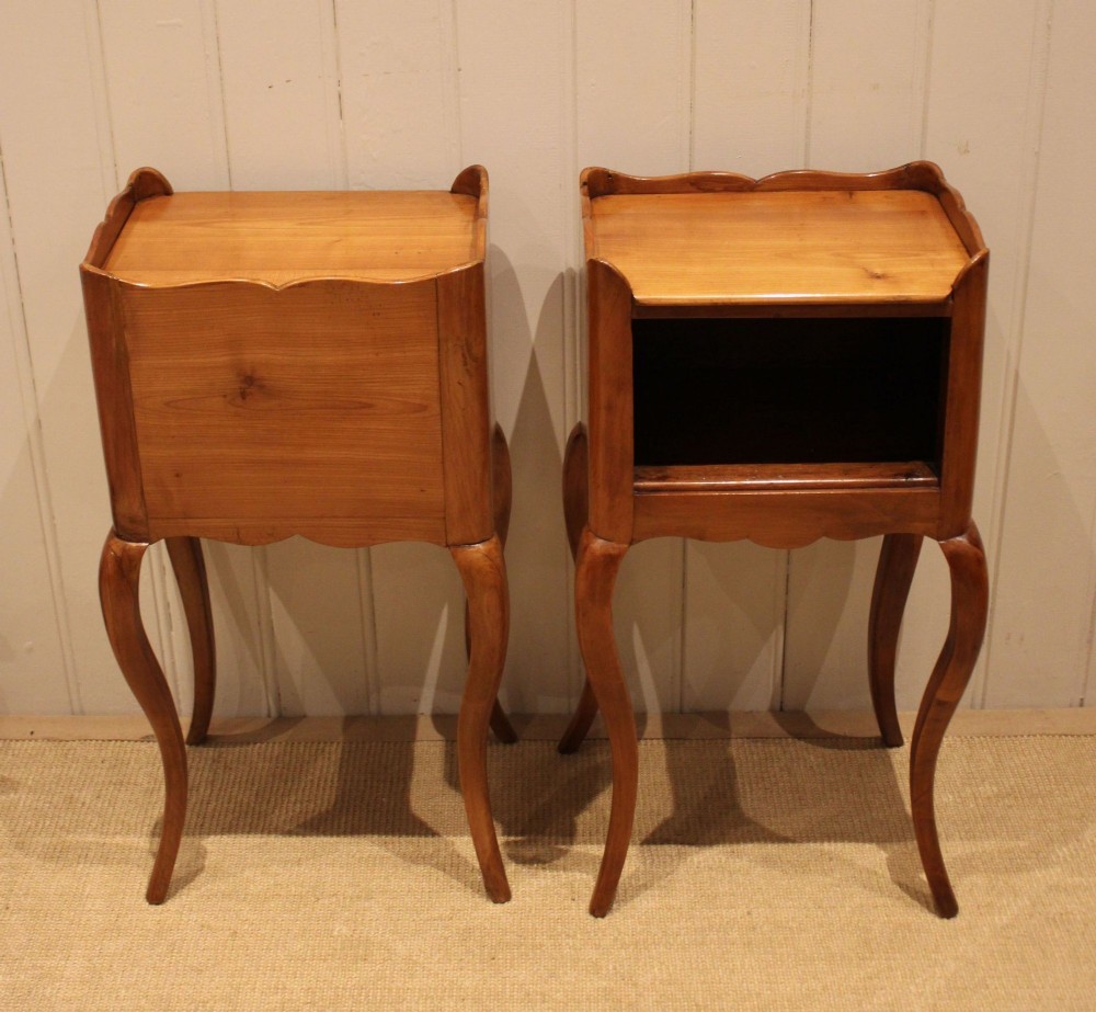 A pair of warm brown cherry wood bedside cabinets featuring open shelf compartments, scalloped top galleries, and slender cabriole legs. View XIII