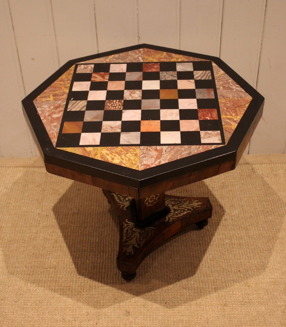 An octagonal Regency rosewood occasional table featuring an inlaid specimen marble chess board top supported by a central column and triform base. View II