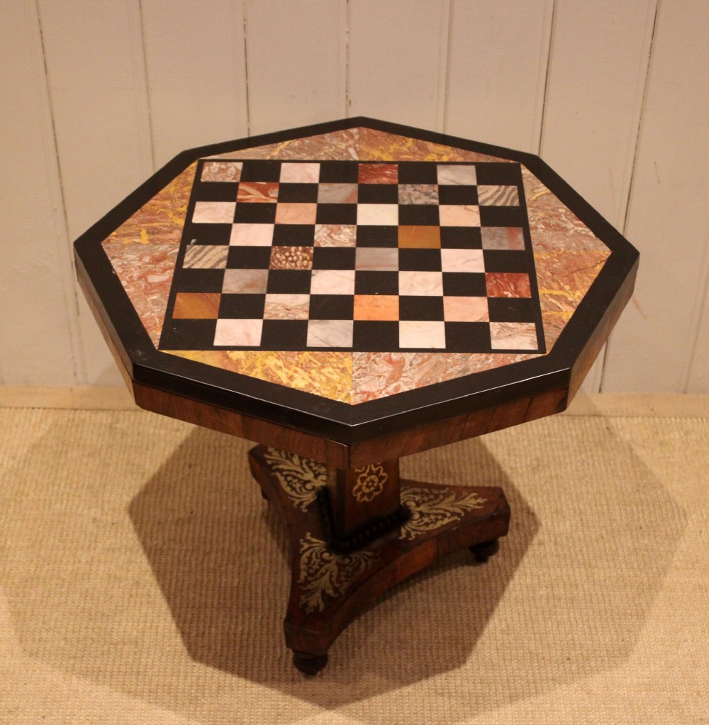 An octagonal Regency rosewood occasional table featuring an inlaid specimen marble chess board top supported by a central column and triform base. View III