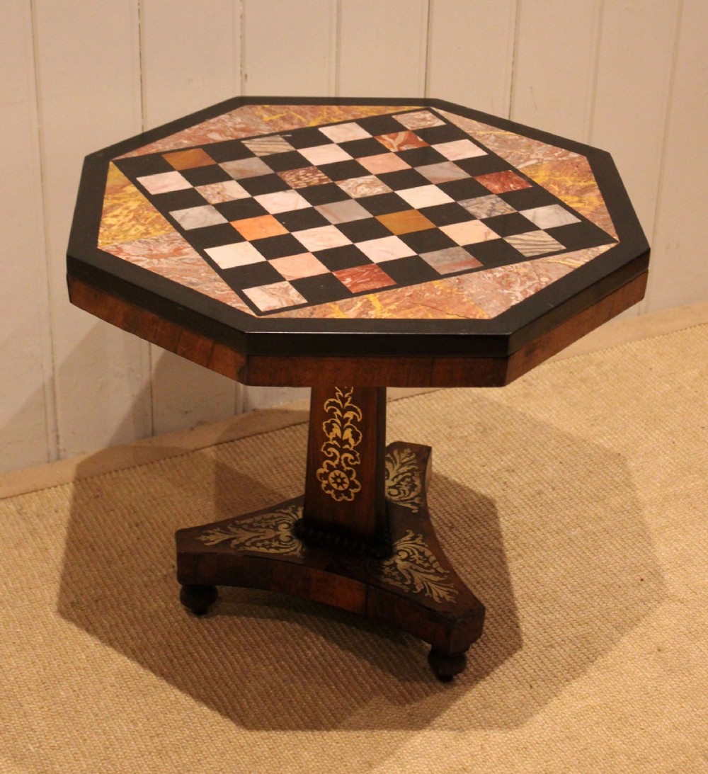An octagonal Regency rosewood occasional table featuring an inlaid specimen marble chess board top supported by a central column and triform base. View VI