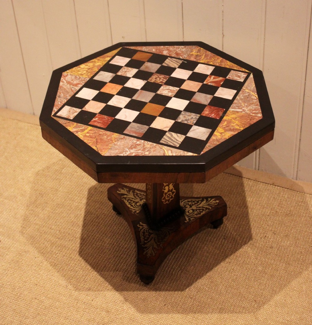 An octagonal Regency rosewood occasional table featuring an inlaid specimen marble chess board top supported by a central column and triform base. View VII