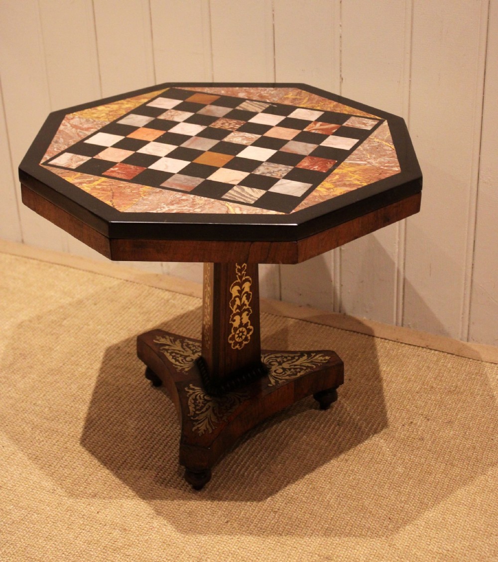 An octagonal Regency rosewood occasional table featuring an inlaid specimen marble chess board top supported by a central column and triform base. View VIII