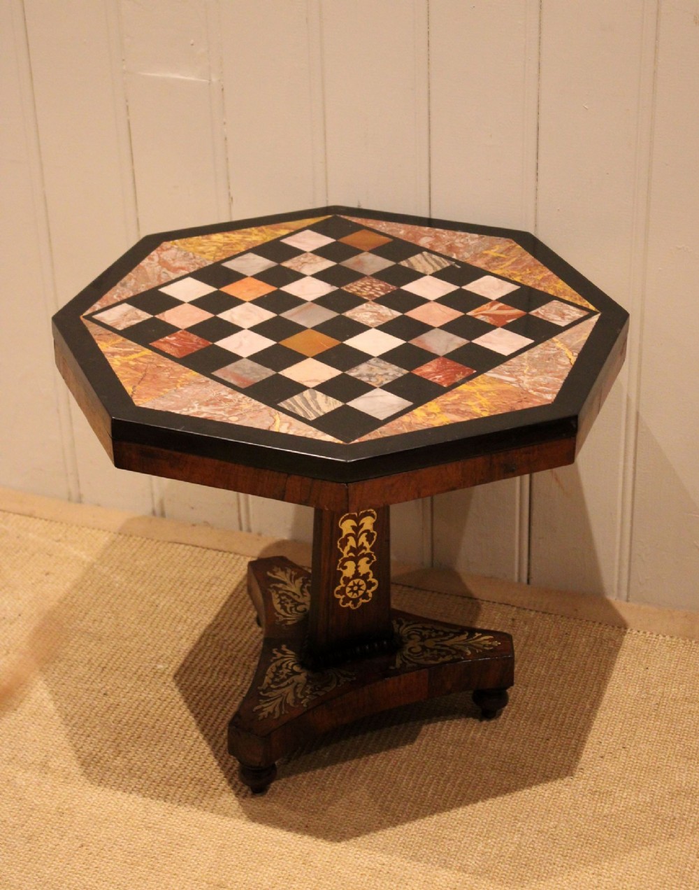 An octagonal Regency rosewood occasional table featuring an inlaid specimen marble chess board top supported by a central column and triform base. View XI