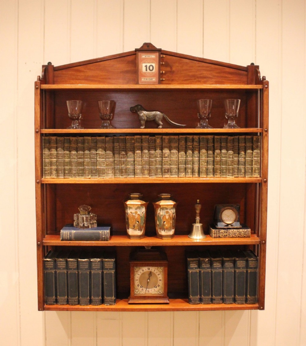 A four-tier mahogany wall-mounted shelving unit featuring open spindled sides and a peaked pediment top. View III
