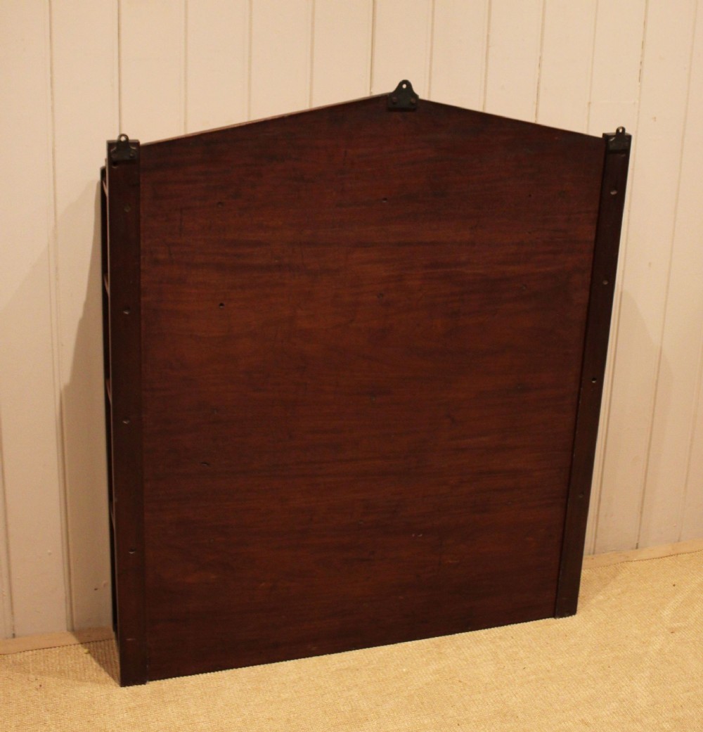 A four-tier mahogany wall-mounted shelving unit featuring open spindled sides and a peaked pediment top. View XII