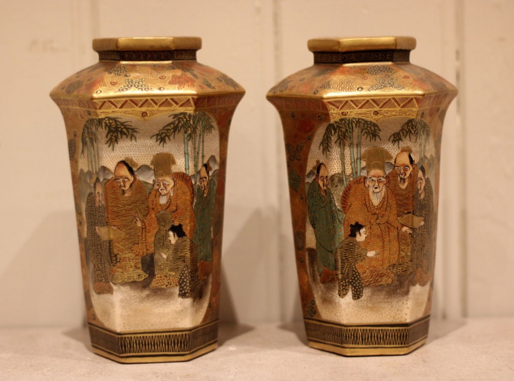A pair of hexagonal Japanese Satsuma ceramic vases painted with figural scenes, mountain landscapes, and heavy gold enamel detailing. View II