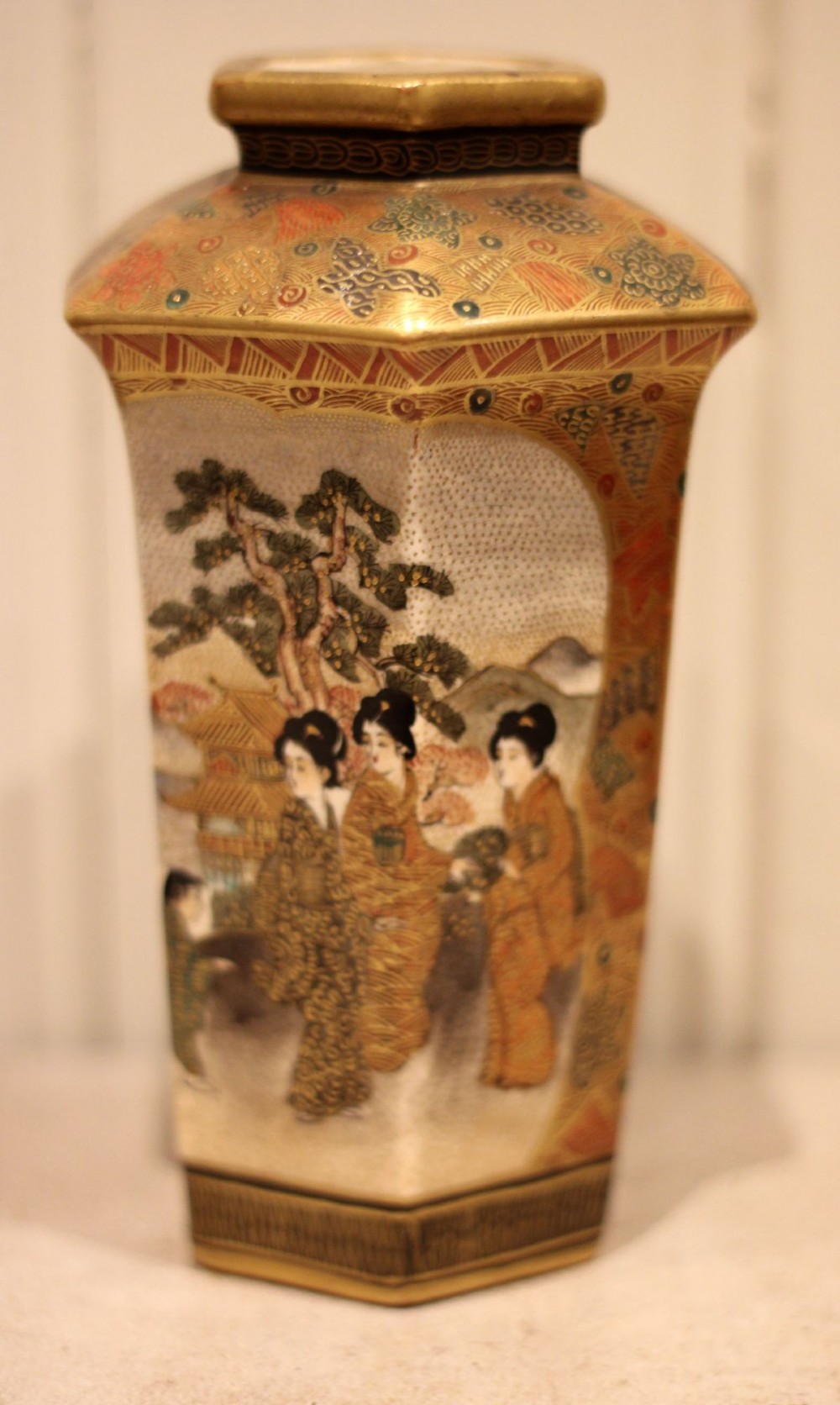 A pair of hexagonal Japanese Satsuma ceramic vases painted with figural scenes, mountain landscapes, and heavy gold enamel detailing. View III