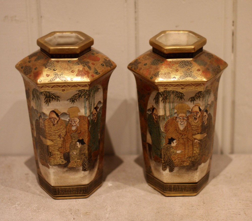 A pair of hexagonal Japanese Satsuma ceramic vases painted with figural scenes, mountain landscapes, and heavy gold enamel detailing. View V