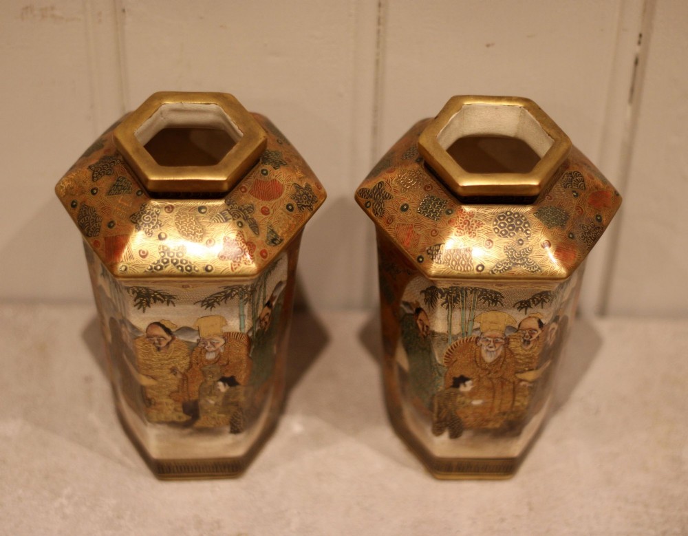 A pair of hexagonal Japanese Satsuma ceramic vases painted with figural scenes, mountain landscapes, and heavy gold enamel detailing. View VIII