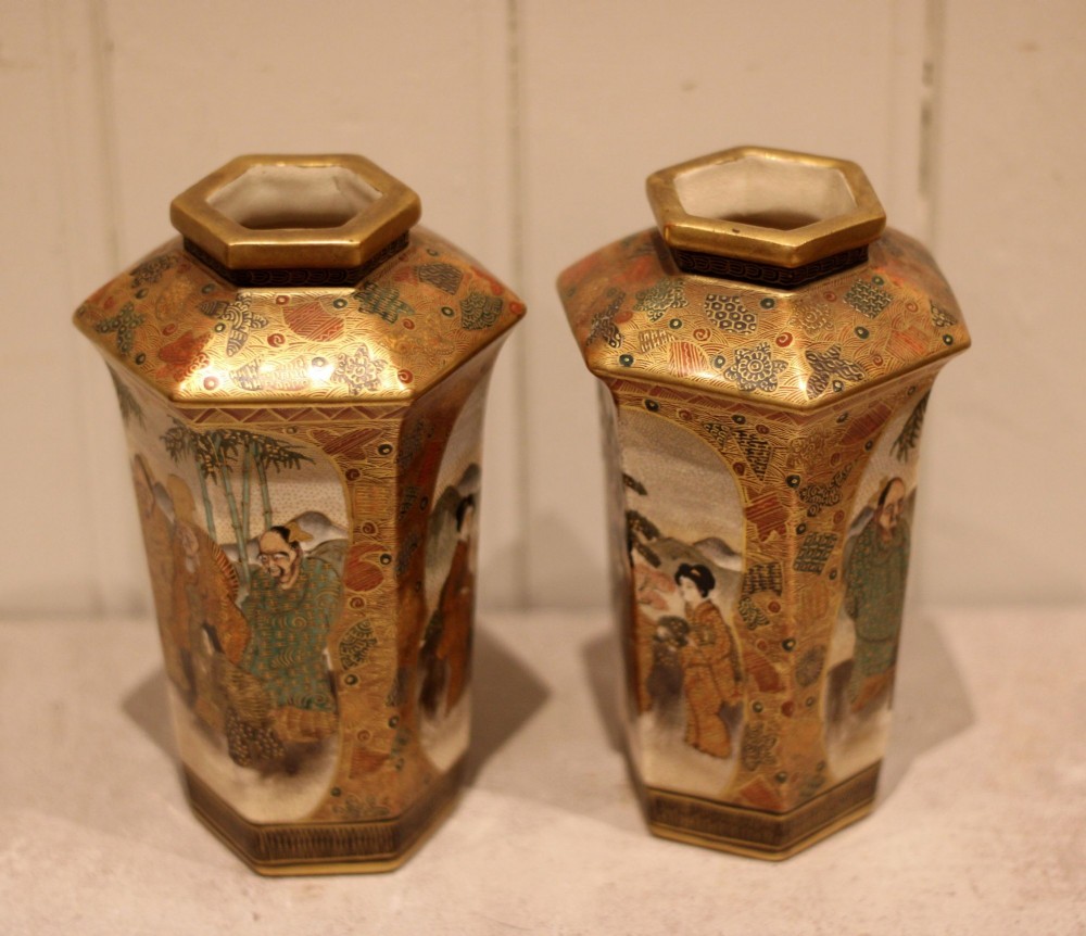 A pair of hexagonal Japanese Satsuma ceramic vases painted with figural scenes, mountain landscapes, and heavy gold enamel detailing. View IX