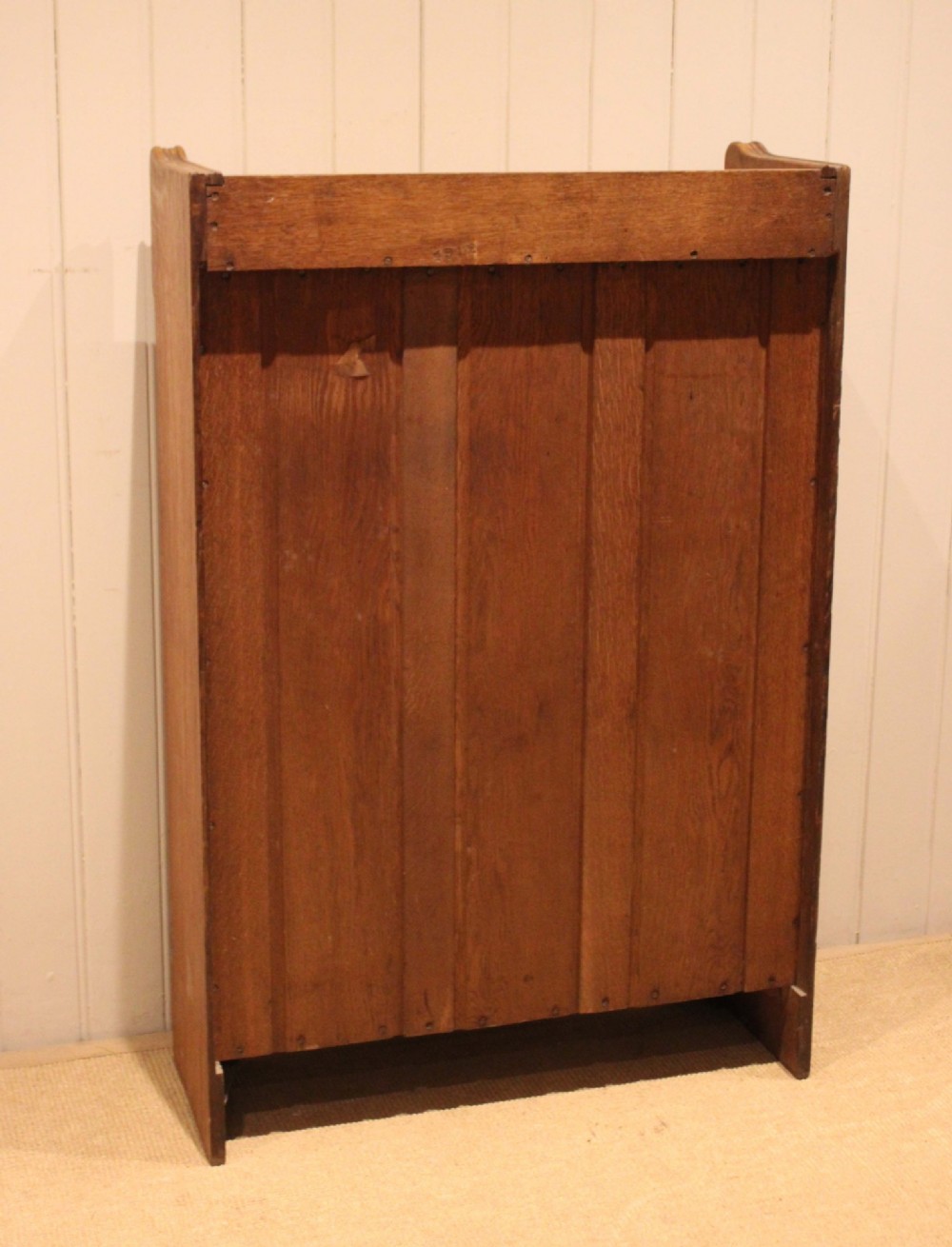 A freestanding light oak open bookcase featuring four horizontal shelves, a raised gallery rail, and curved side brackets. View XIII