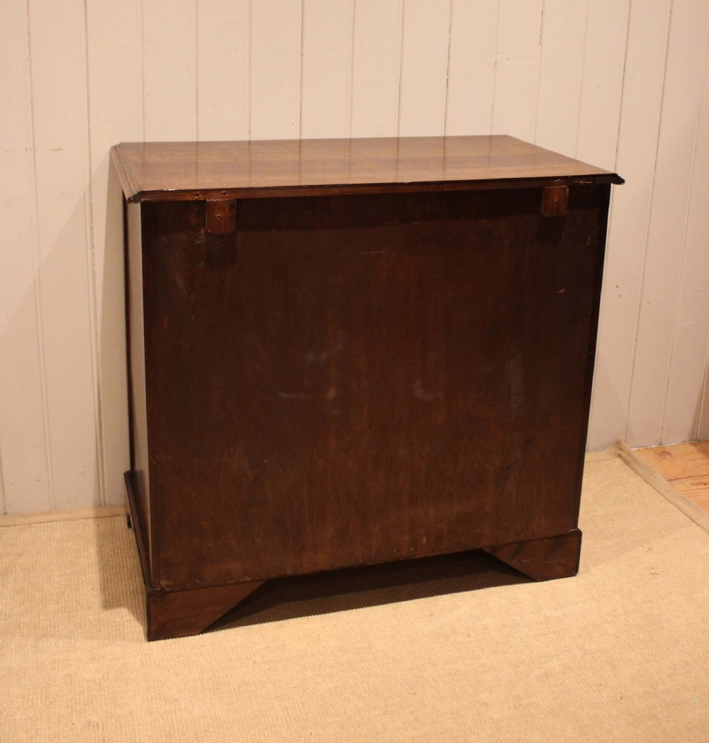 A solid oak chest of drawers featuring three full-width drawers with circular brass drop ring handles and bracket feet. View XIII