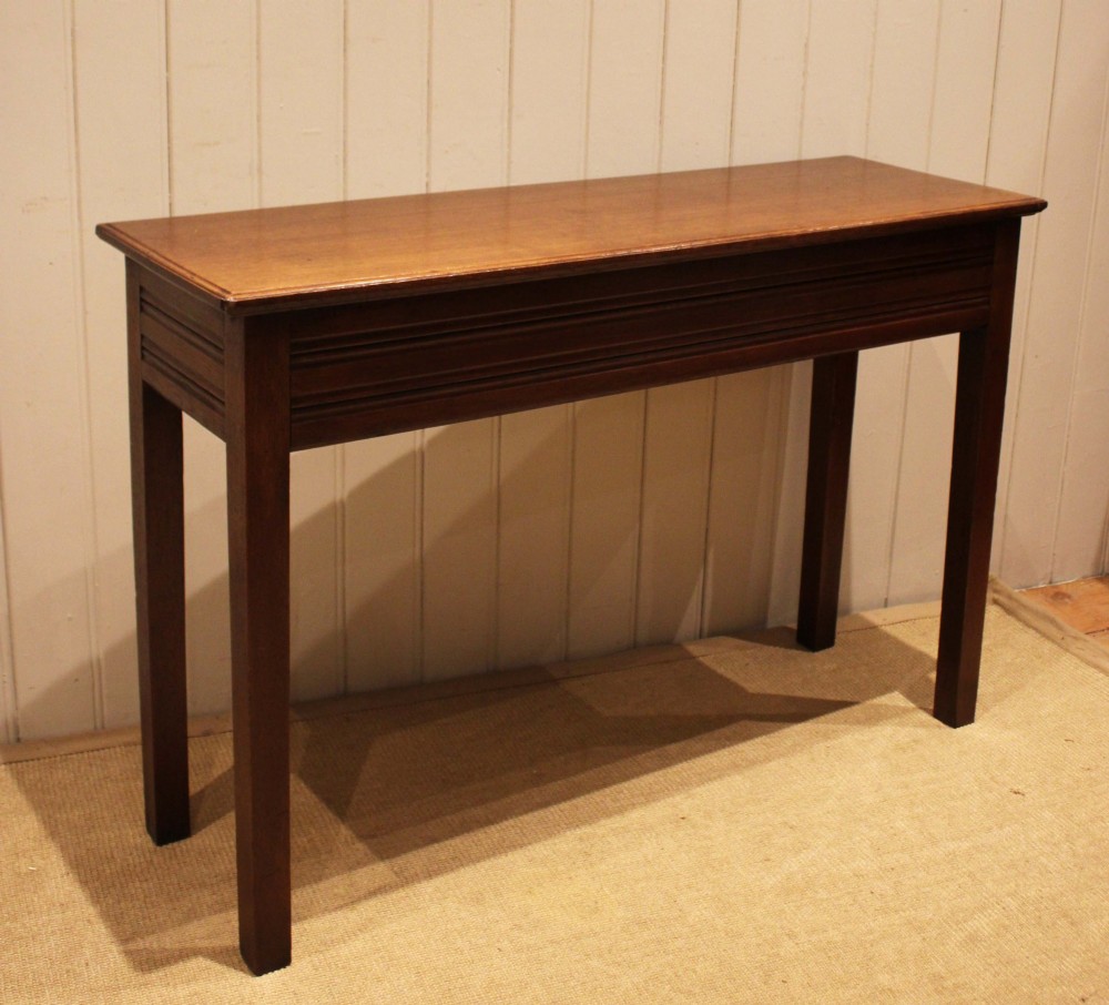 A late 19th-century oak hall table with a rectangular top, grooved apron detail, and four straight legs. View III