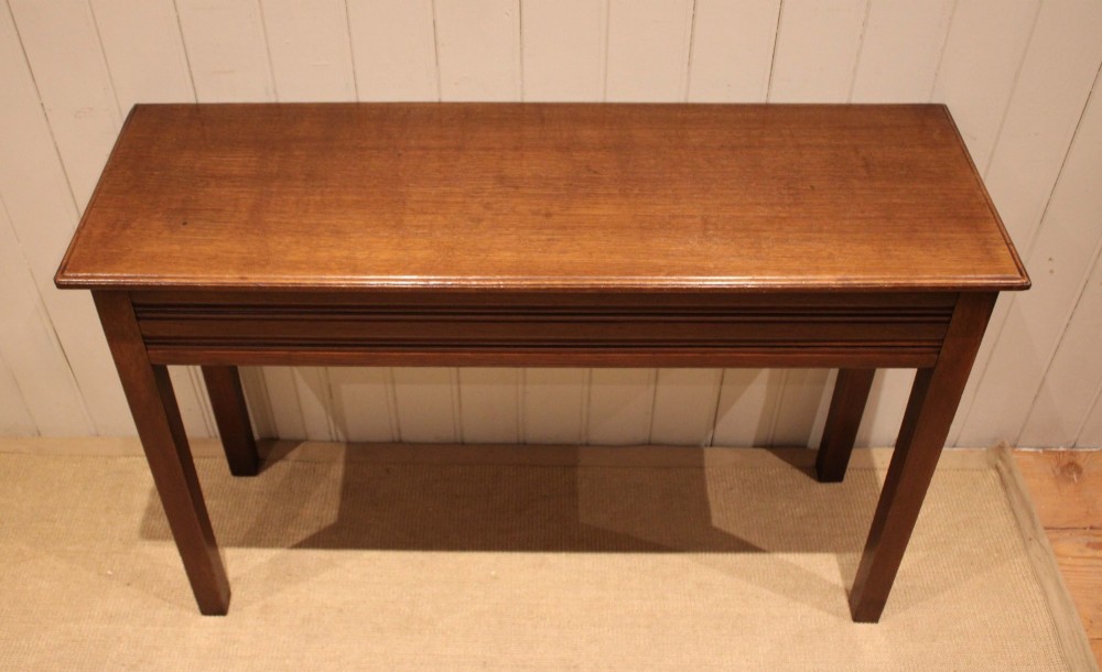 A late 19th-century oak hall table with a rectangular top, grooved apron detail, and four straight legs. View V