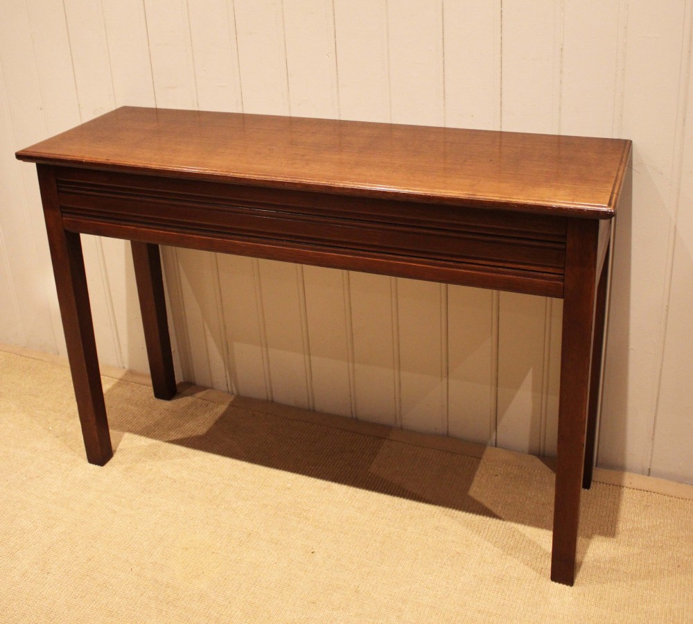 A late 19th-century oak hall table with a rectangular top, grooved apron detail, and four straight legs. View VII