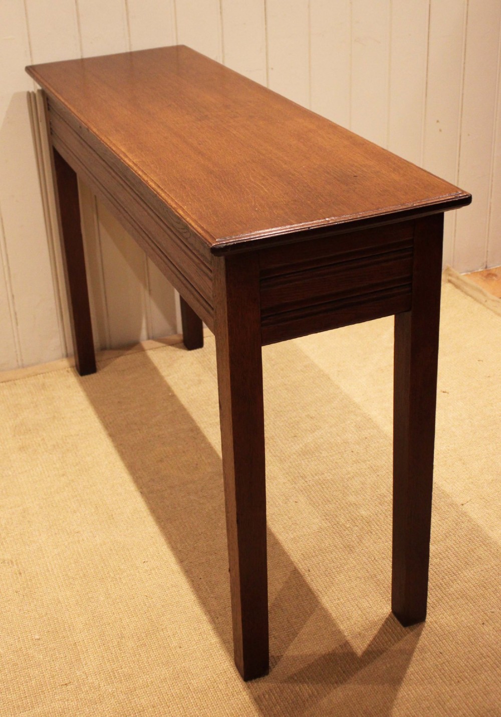 A late 19th-century oak hall table with a rectangular top, grooved apron detail, and four straight legs. View VIII