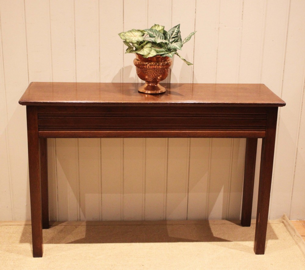 A late 19th-century oak hall table with a rectangular top, grooved apron detail, and four straight legs. View XI