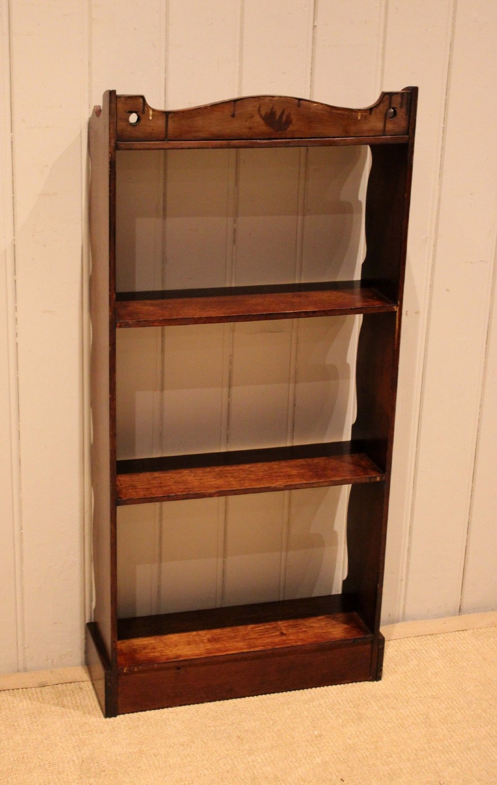 A small dark oak open bookcase featuring four tier shelves, shaped side panels, and a scrolled top gallery. View XIII