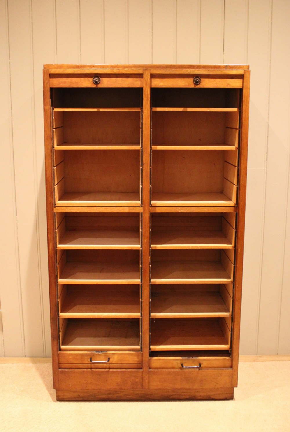 A tall French oak filing cabinet featuring twin vertical tambour slatted doors with metal handles and keyholes. View II