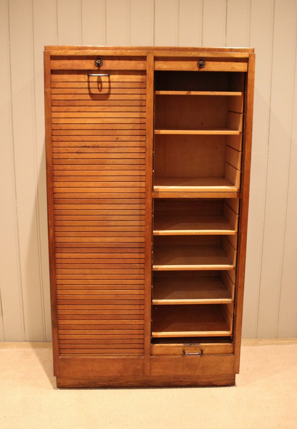 A tall French oak filing cabinet featuring twin vertical tambour slatted doors with metal handles and keyholes. View IV