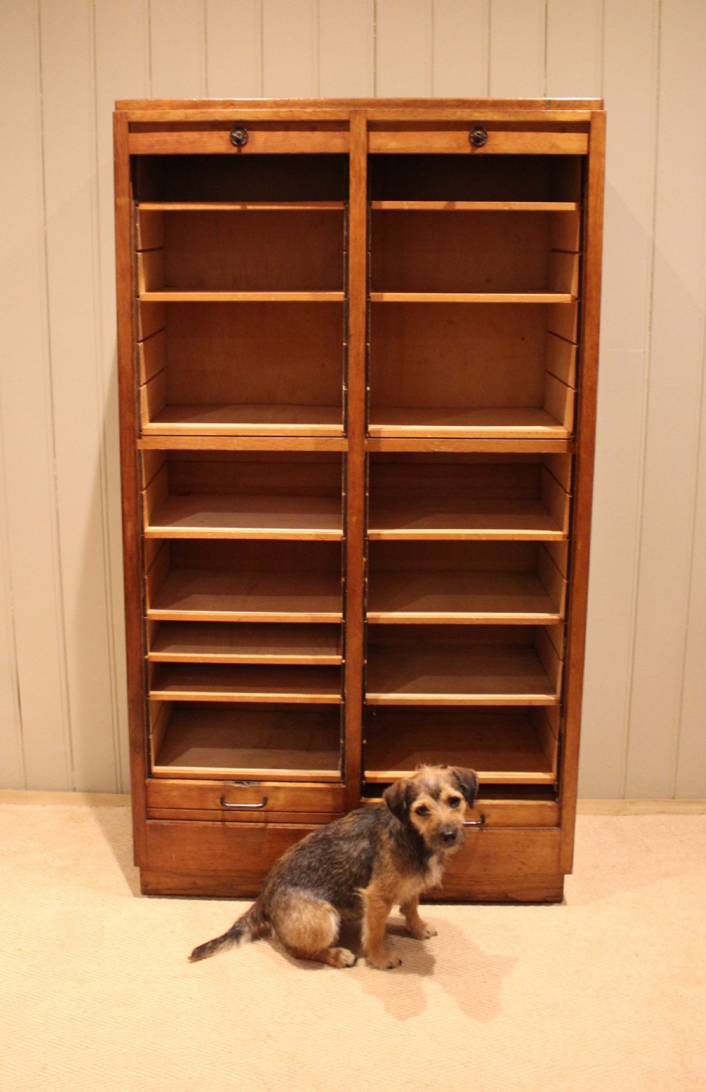 A tall French oak filing cabinet featuring twin vertical tambour slatted doors with metal handles and keyholes. View VI