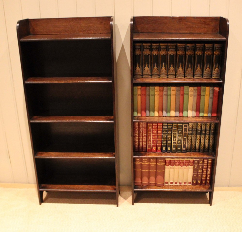 A tall dark oak open bookcase with four fixed shelves and shaped side profile cut-outs at the base. View XIII