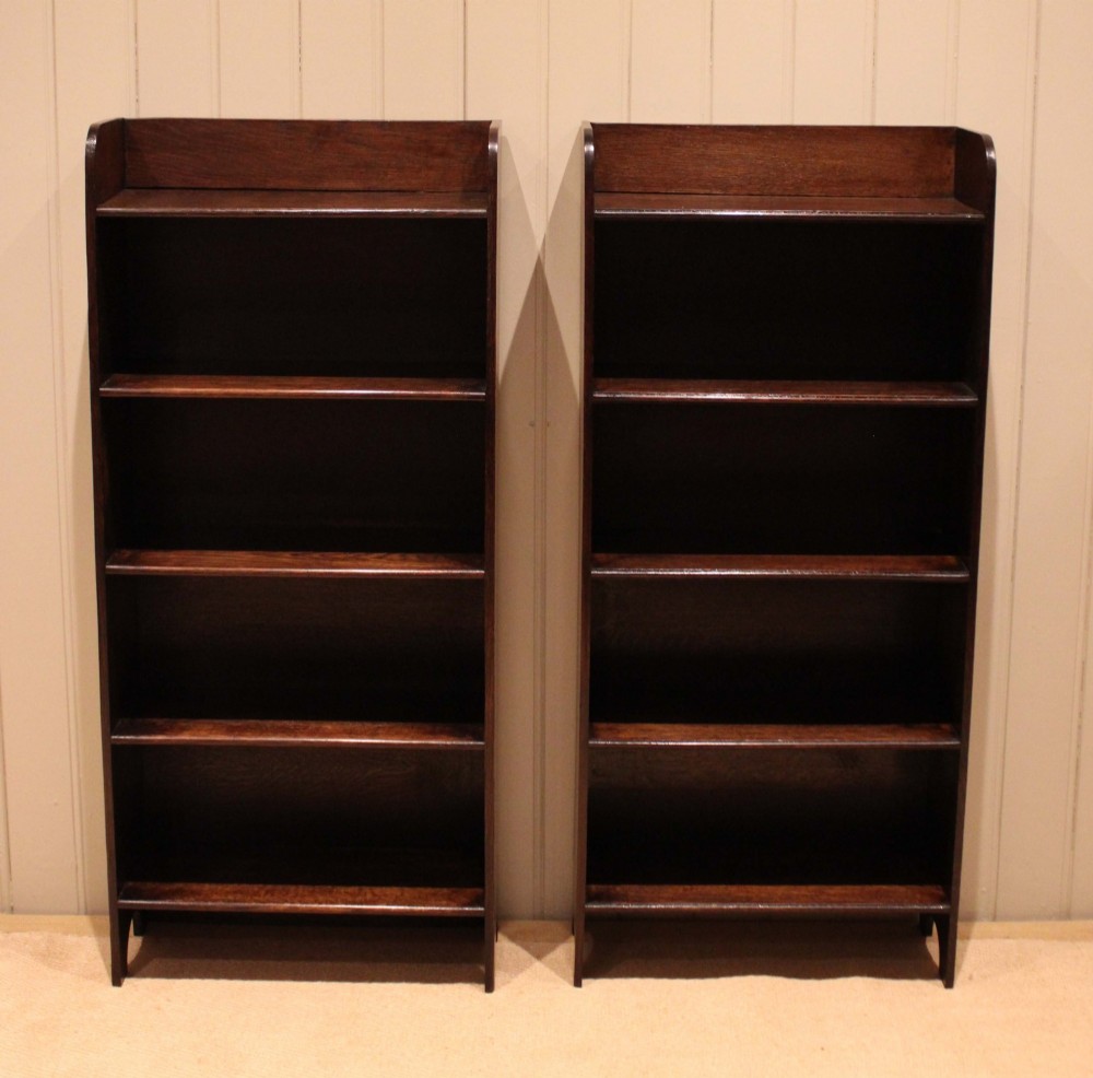 A tall dark oak open bookcase with four fixed shelves and shaped side profile cut-outs at the base. View XIV