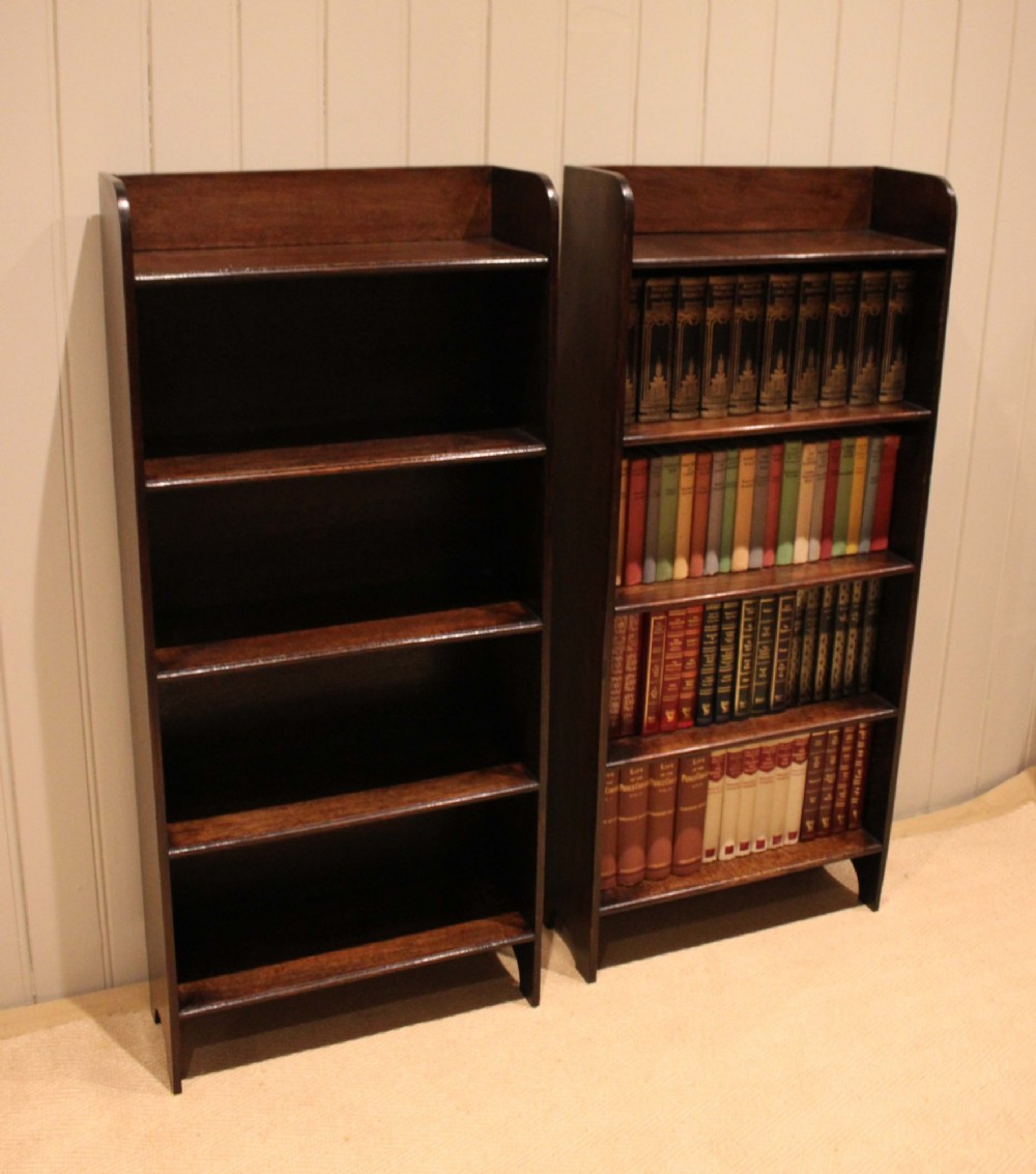 A tall dark oak open bookcase with four fixed shelves and shaped side profile cut-outs at the base. View XV