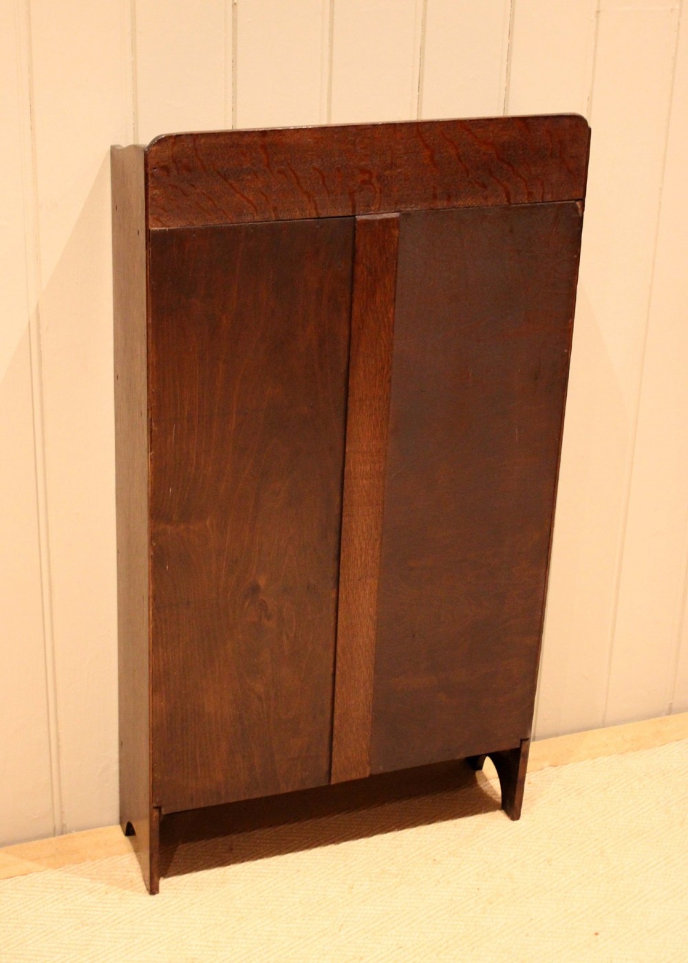 A small dark oak open bookcase with three horizontal shelves filled with vintage books and a shaped top gallery. View XII