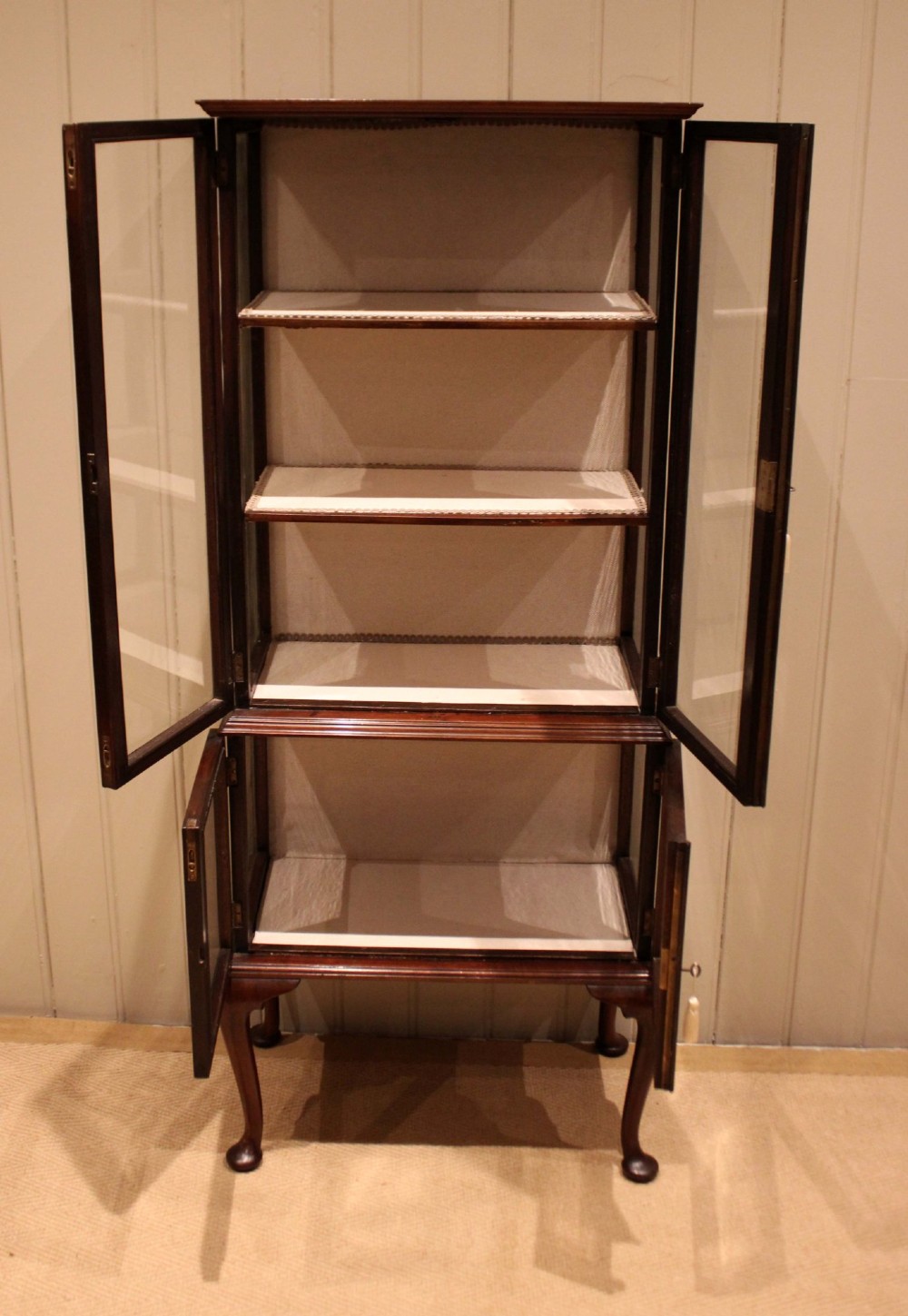 An Edwardian dark mahogany display cabinet with glazed doors and sides, resting on cabriole legs with pad feet. View XI