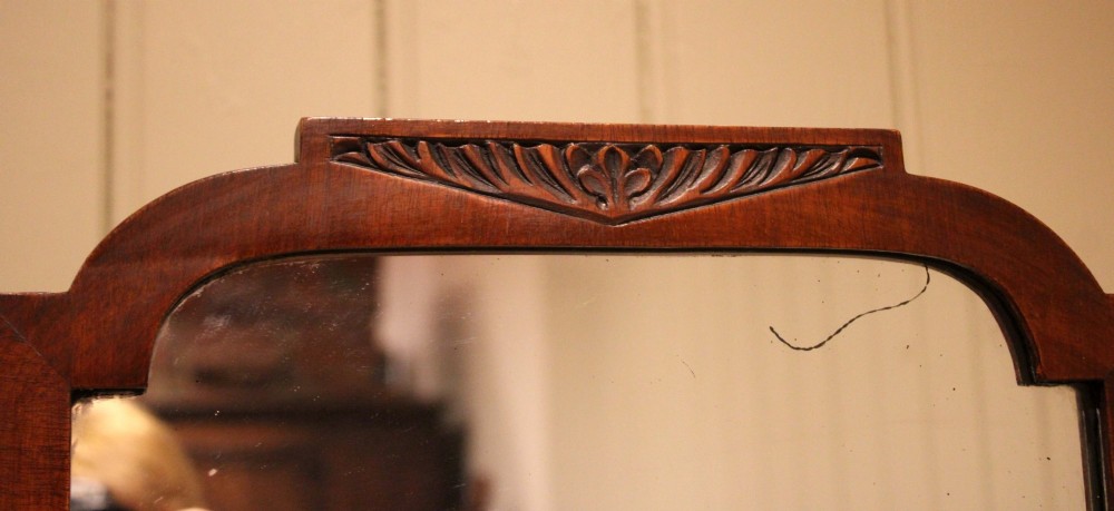 A full-length mahogany cheval mirror with a rectangular swivelling frame, shaped top cresting, and splayed legs. View X