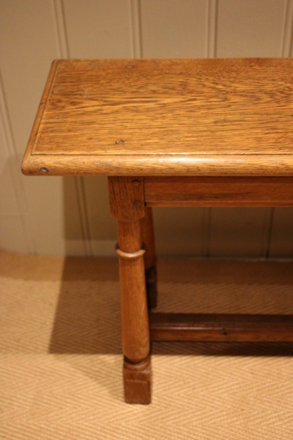 A long rectangular solid oak bench featuring turned legs connected by a low stretcher rail. View VI