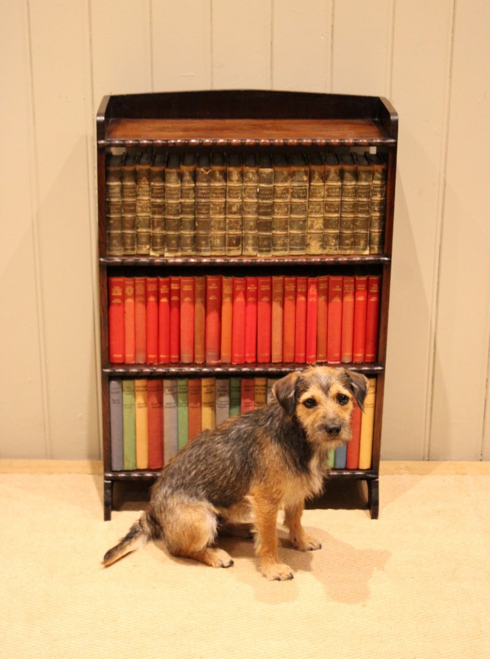 A small dark oak open bookcase with three fixed shelves and beaded edge moulding along each front shelf border. View IX