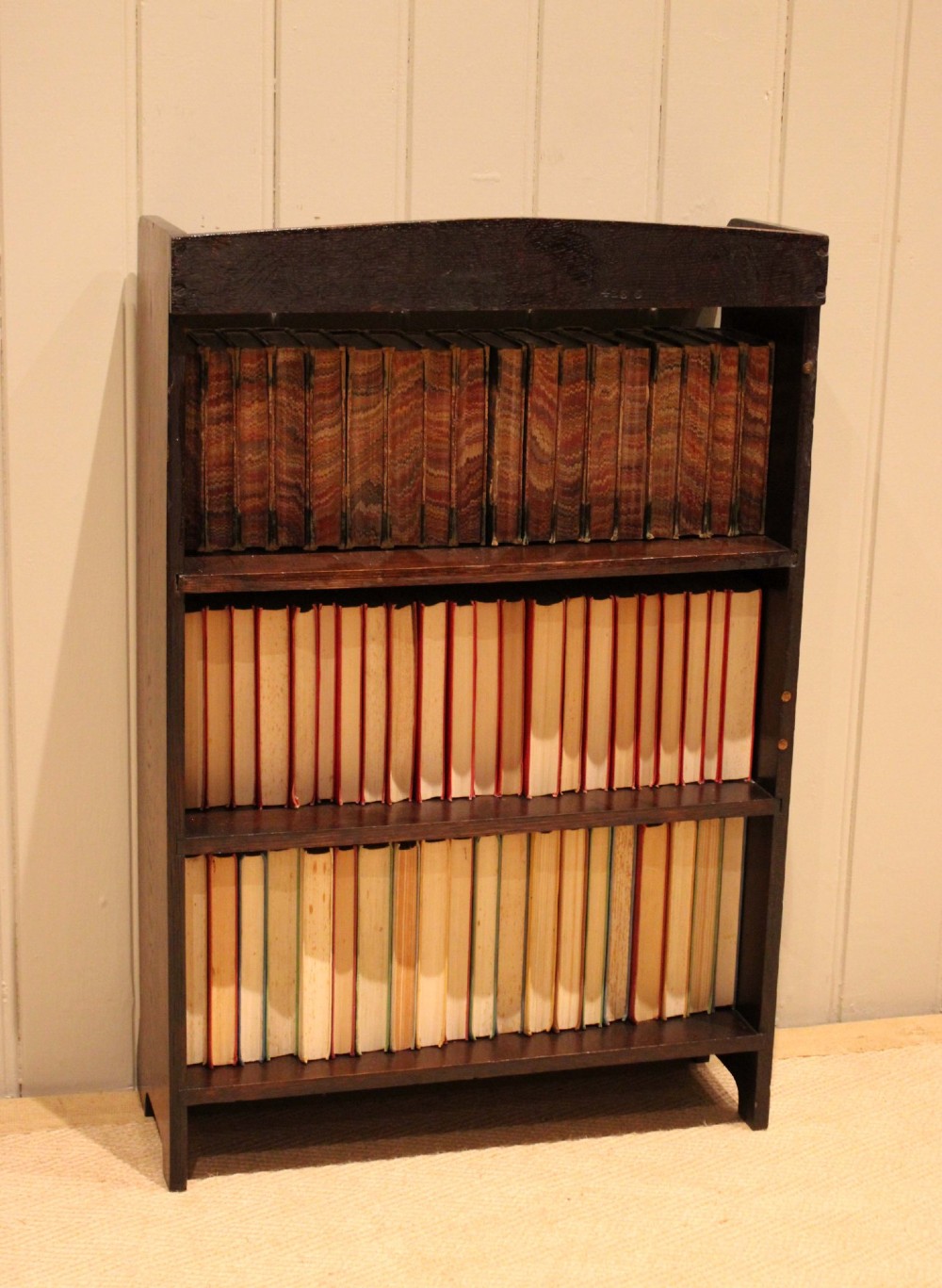 A small dark oak open bookcase with three fixed shelves and beaded edge moulding along each front shelf border. View XI