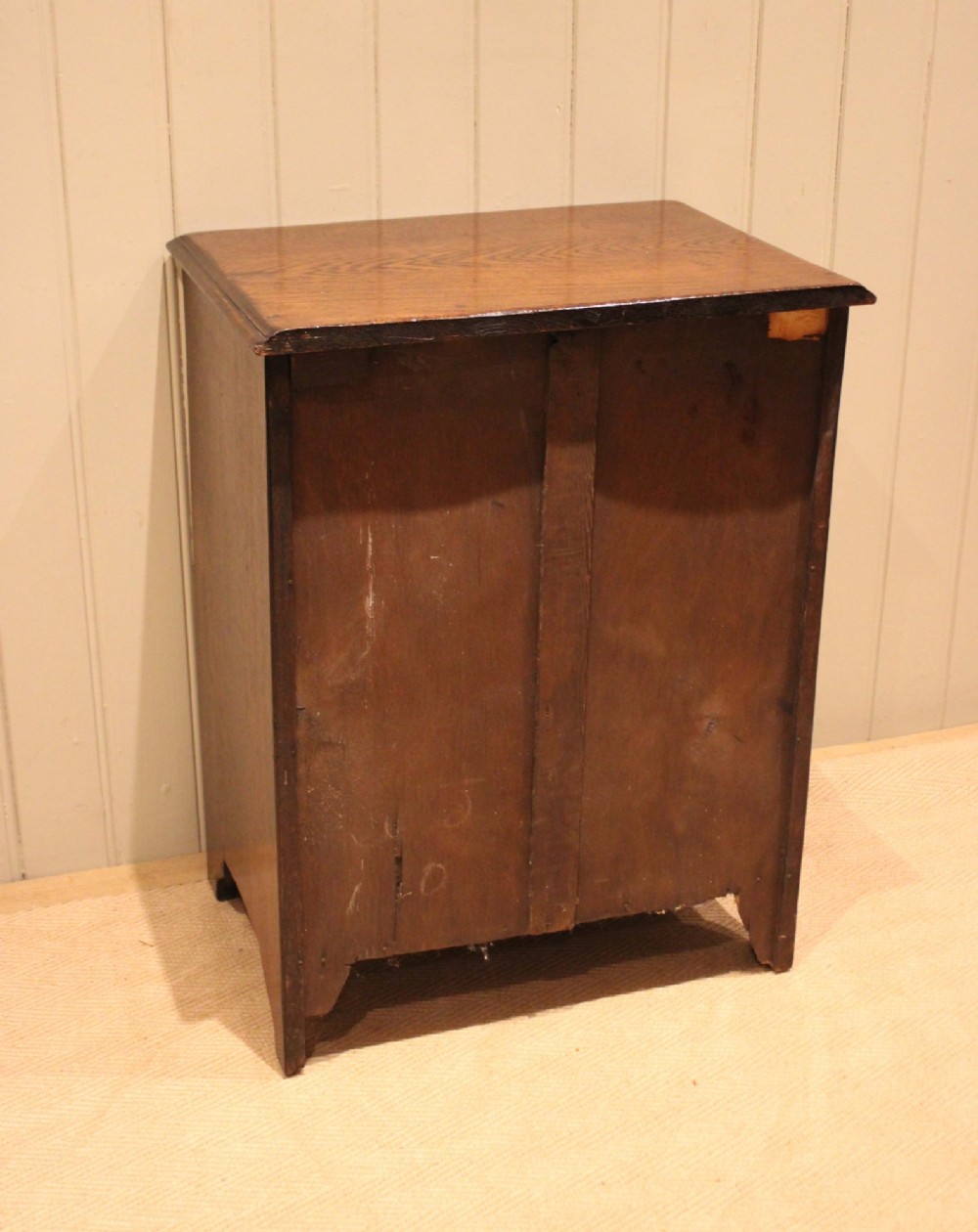 A small solid oak chest of four drawers featuring turned wooden knobs and incised border detailing. View XIII