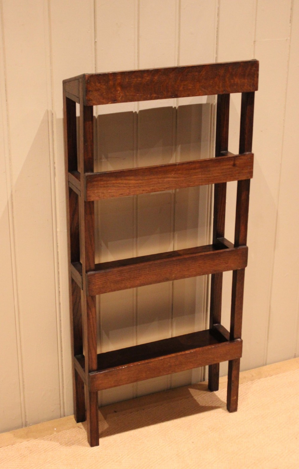 A tall, narrow Edwardian dark oak open-back bookcase featuring four horizontal shelves and straight square legs. View XIII