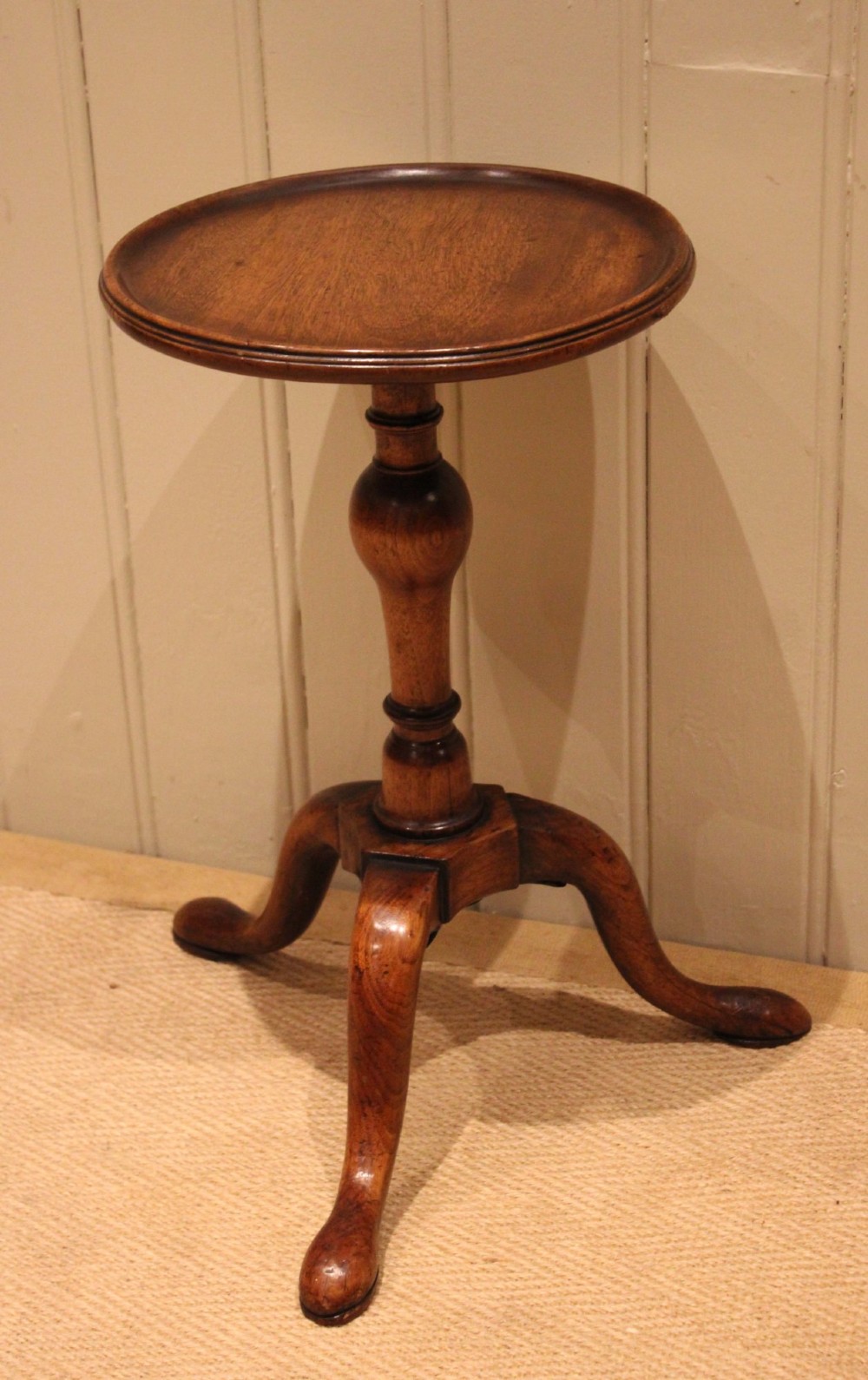 A Georgian mahogany wine table featuring a circular dished top supported by a turned baluster column and tripod pad feet. View VII