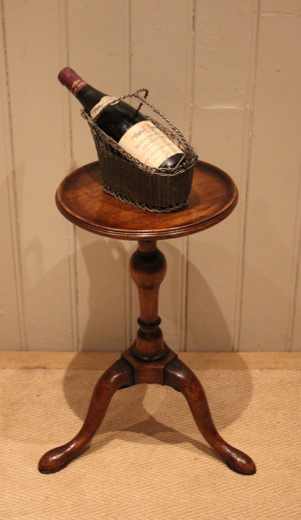 A Georgian mahogany wine table featuring a circular dished top supported by a turned baluster column and tripod pad feet. View VIII