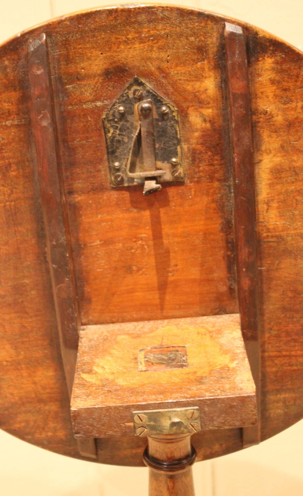 A circular mahogany tilt-top wine table with a turned central pedestal column and a tripod base featuring cabriole legs. View XII