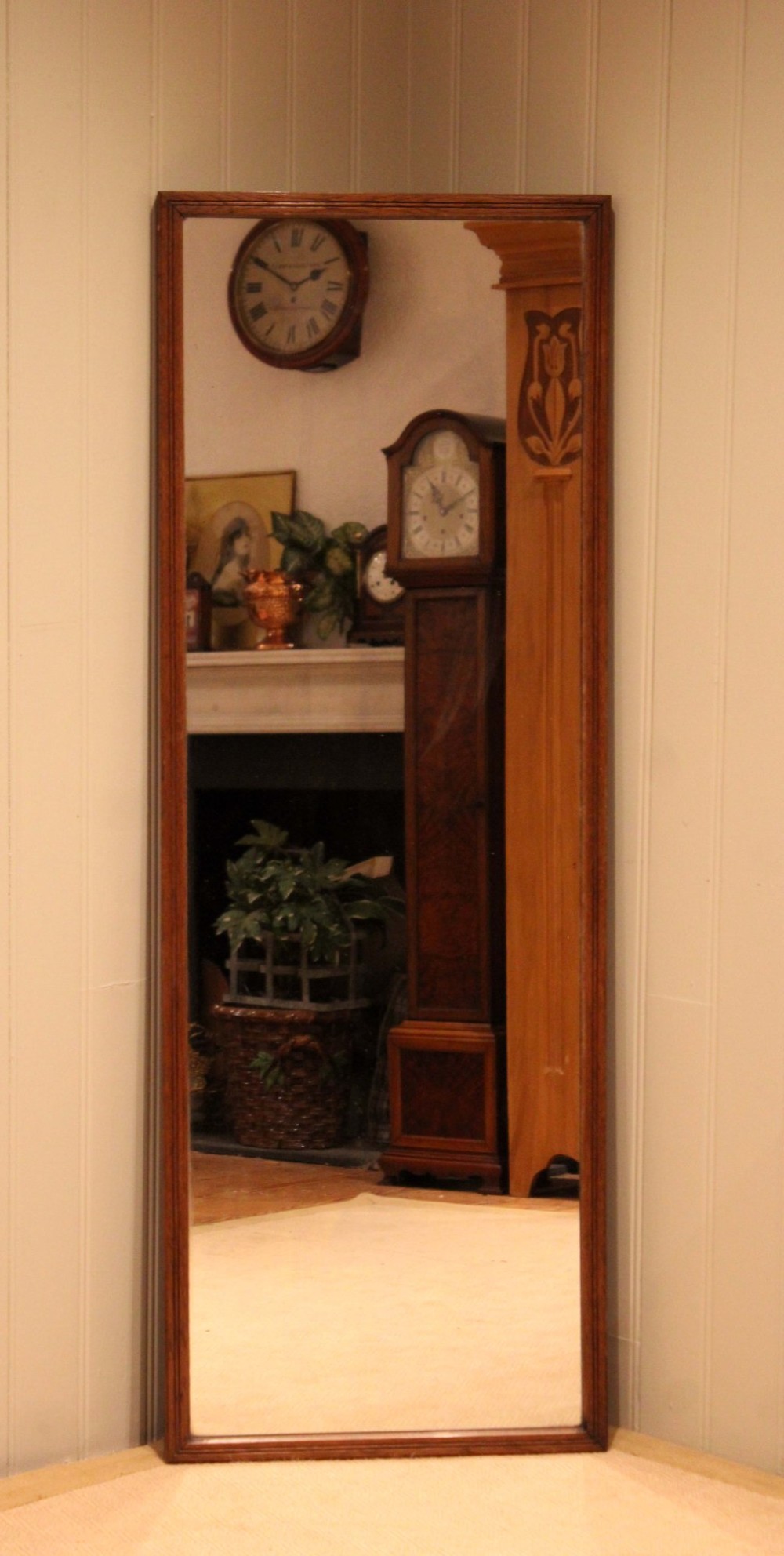 A large rectangular full-length mirror featuring a slender moulded oak frame with visible natural grain. View V