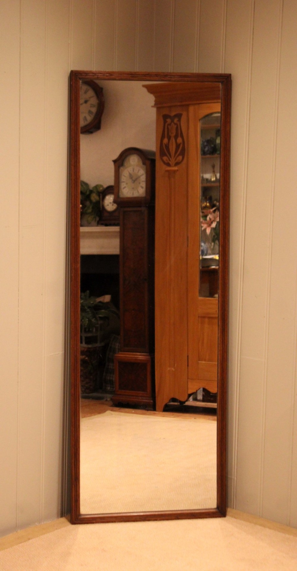 A large rectangular full-length mirror featuring a slender moulded oak frame with visible natural grain. View VIII