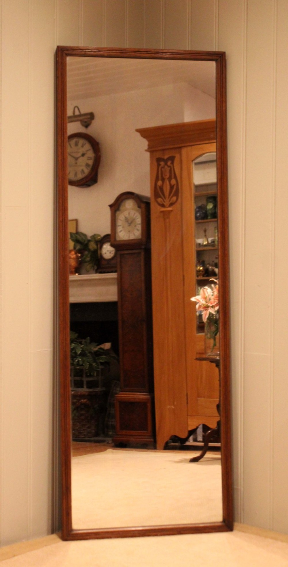 A large rectangular full-length mirror featuring a slender moulded oak frame with visible natural grain. View IX
