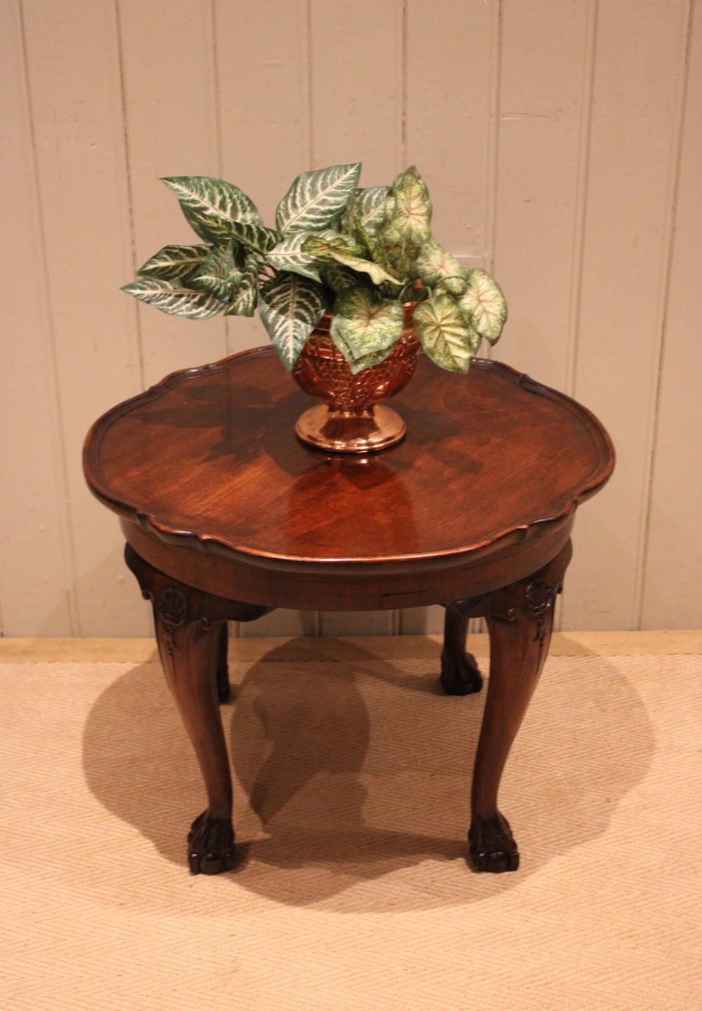 A low mahogany coffee table featuring a shaped piecrust rim, carved cabriole legs with shell knee detailing, and claw and ball feet. View III