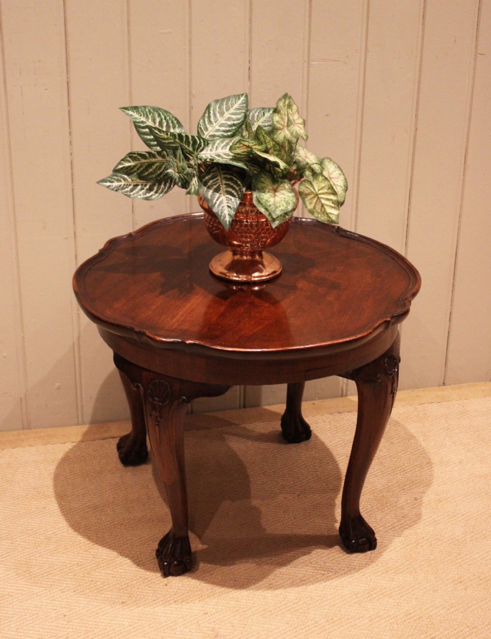 A low mahogany coffee table featuring a shaped piecrust rim, carved cabriole legs with shell knee detailing, and claw and ball feet. View VI