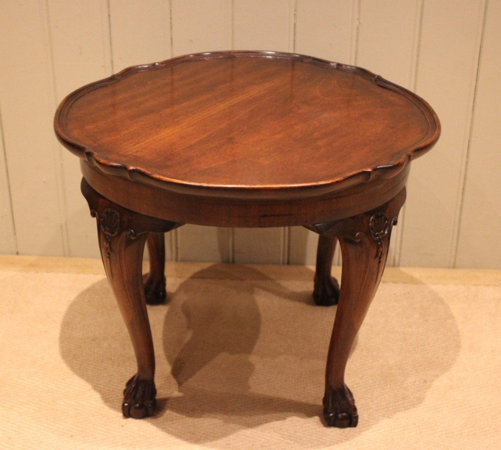 A low mahogany coffee table featuring a shaped piecrust rim, carved cabriole legs with shell knee detailing, and claw and ball feet. View VIII