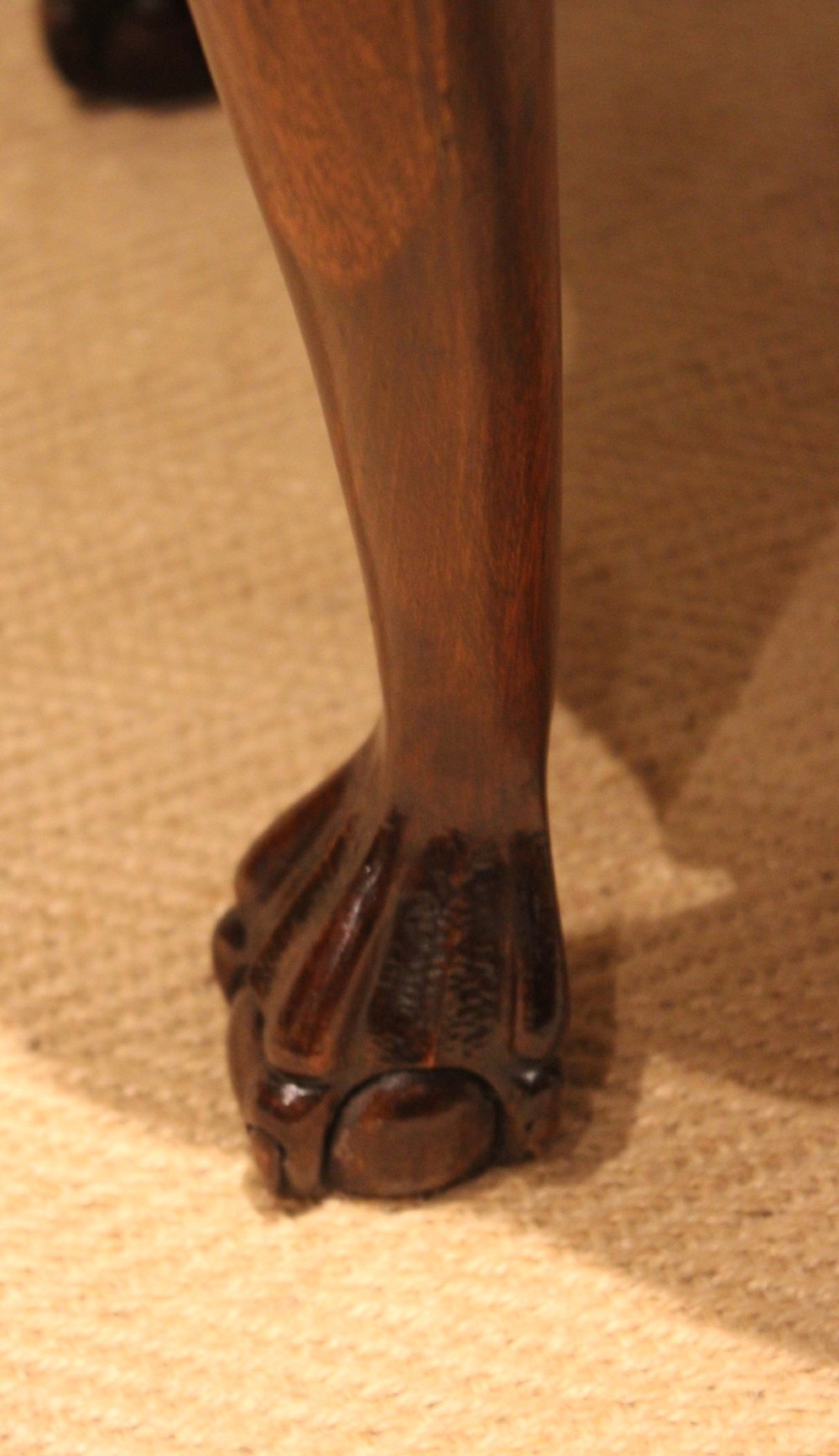 A low mahogany coffee table featuring a shaped piecrust rim, carved cabriole legs with shell knee detailing, and claw and ball feet. View XII