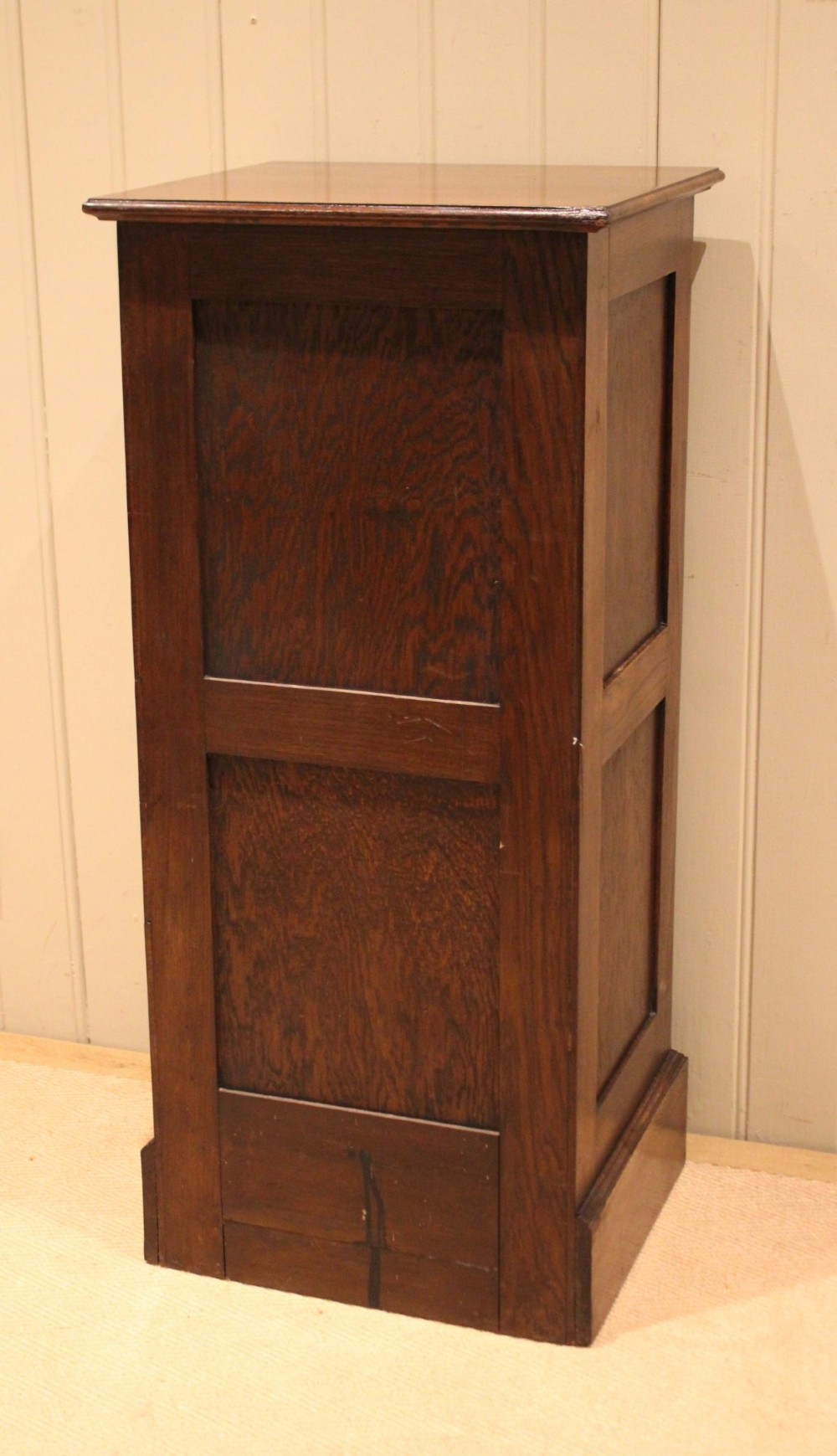 A tall dark oak single-column filing cabinet featuring a slatted wooden tambour front with top brass pull knobs and a keyhole escutcheon. View XII